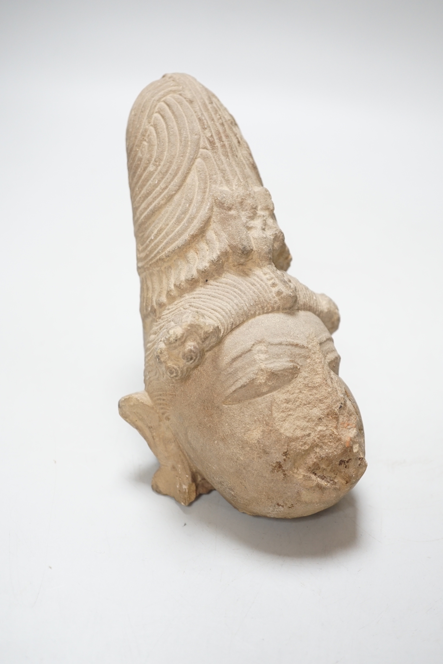 An Indian carved sandstone head of a Hindu deity, 19.5cm